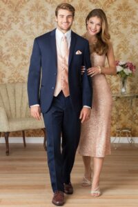 Dashing Teen wearing a navy suit with blush vest and accents to match his prom date's dress.