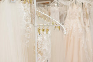 Rack of wedding dress viels being held up by golden clips.