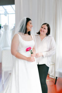 Courtney Foreman helping bride with gown