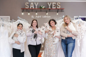 Wedding With Joy's Bridal Team holding cute huskie puppies in front of their Joyful private lable collection.