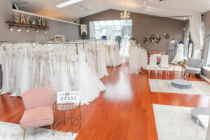Weddings with Joy showroom with several bridal gowns on racks