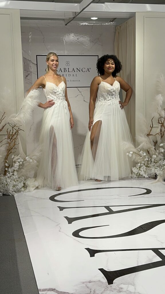 Two lovely brides modeling Casablanca Bridal wedding dresses at the Chicago Bridal Market 2024.