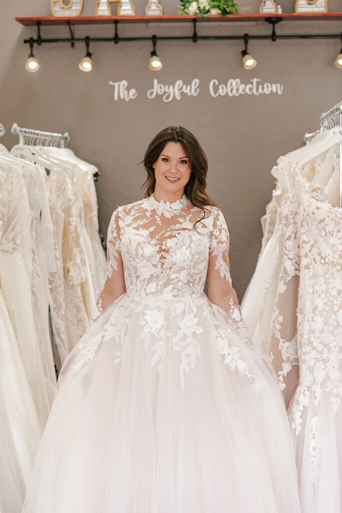 Illusion lace wedding dress with long sleeves and high neckline. Weddings with Joy. 