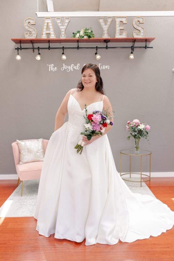 Simple ball gown wedding dress with spaghetti straps and pockets. Weddings with Joy. 