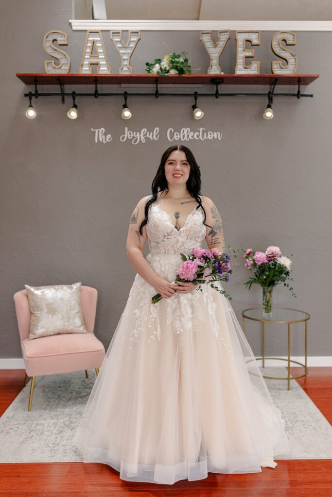 Floral lace a-line wedding dress with straps and tulle skirt. Weddings with Joy. 