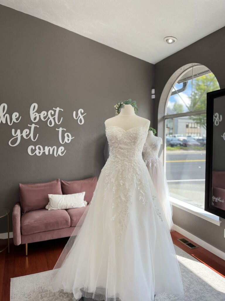 Strapless a-line wedding dress with floral lace detailing and tulle skirt. Weddings with Joy.