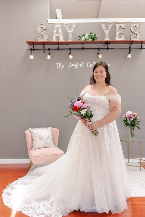 Off the shoulders plus size wedding dress with lace details, ball gown. Weddings with Joy.