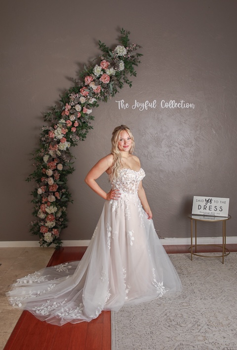 Strapless, floral lace bodice wedding dress with lace detail on wedding dress train. Weddings with Joy.