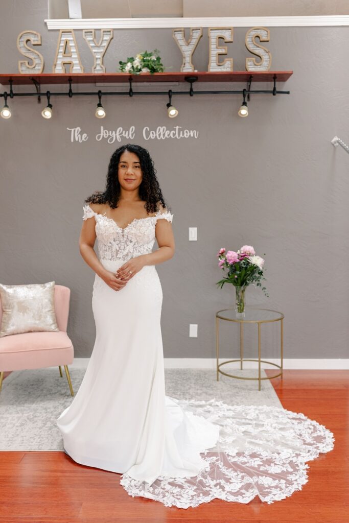 Floral lace wedding dress with off the shoulders straps. Weddings with Joy. 