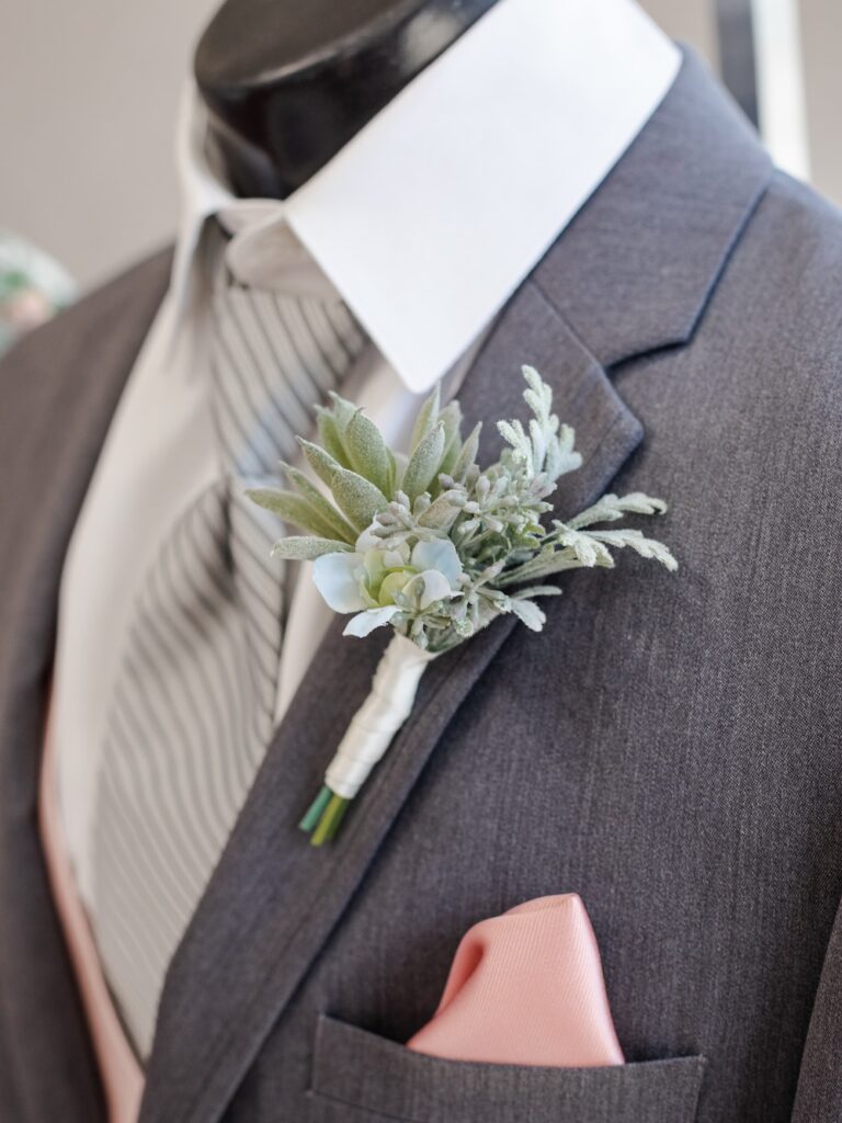 charcoal grey wedding suit with striped tie and blush pink pocket square. weddings with joy