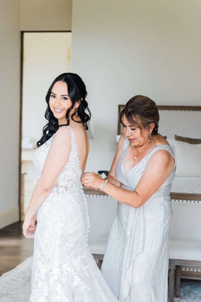 Open back lace wedding dress with buttons on back. mother of bride in silver sparkle dress. Weddings with Joy. 