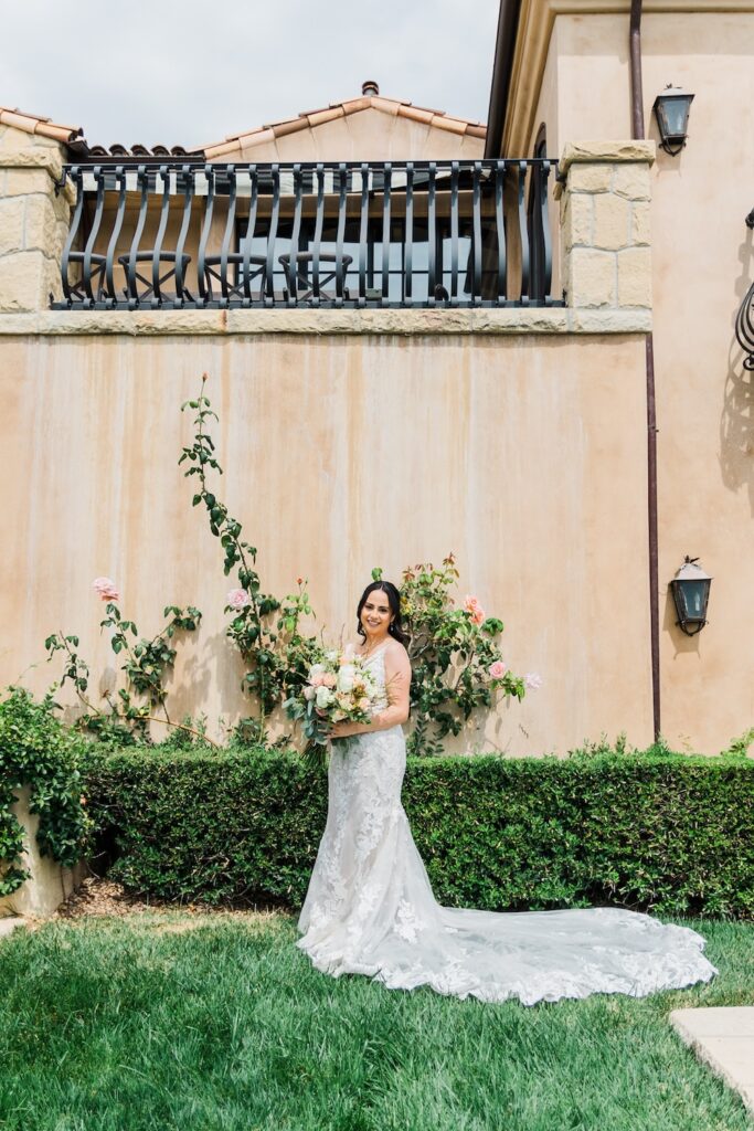 bride in lace wedding dress with straps and long dress train. Weddings with Joy. 