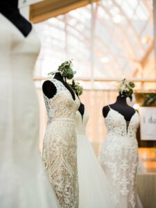 Mannequins showcasing white sleeveless wedding dresses