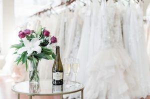 Bottle of Champagne and vase of flowers in bridal store