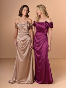 two smiling women in formal dresses
