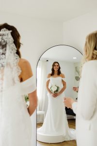 bride wearing bridal dress and holding bouquet of flowers